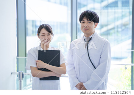 Smiling male doctor and nurse talking at the hospital 115312564