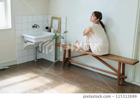 A woman relaxing wearing relaxed wear A woman relaxing wearing relaxed wear 115312699