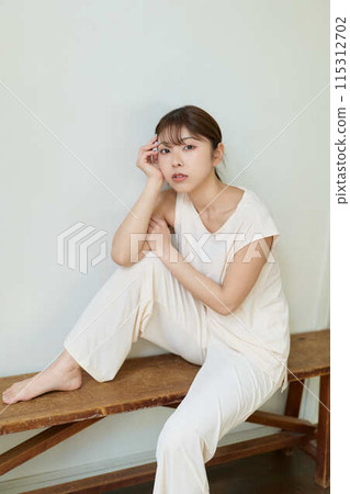 A woman relaxing wearing relaxed wear A woman relaxing wearing relaxed wear 115312702
