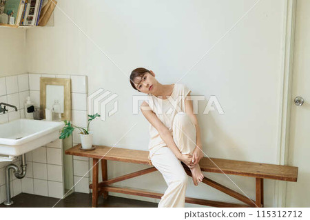 A woman relaxing wearing relaxed wear A woman relaxing wearing relaxed wear 115312712