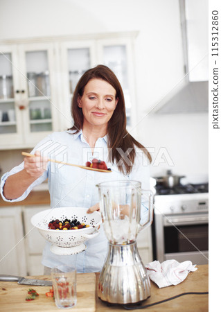 Blender, kitchen and woman with fruit for smoothie, healthy food, vegan diet and nutrition for wellness. Smile, female person and appliance for berry drink with protein and organic breakfast in home Blender, kitchen and woman with fruit for smoothie, healthy food, vegan diet and nutrition for wellness. Smile, female person and appliance for berry drink with protein and organic breakfast in home 115312860