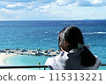 A girl watching the sea 115313221