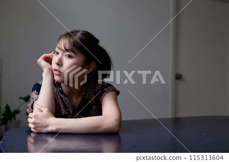 A woman relaxing in the living room A woman relaxing in the living room 115313604