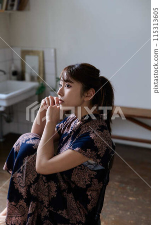 A woman relaxing in the living room A woman relaxing in the living room 115313605