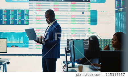 Chief financial officer studying capital funds and revenue data on big screen, verifying annual reports and budget allocation for a project. Looking for ways to increase profit. Camera A. 115313657