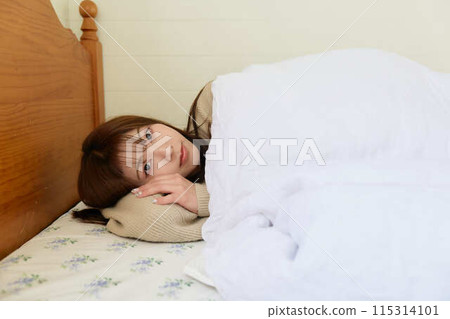 A woman sleeping in bed A woman sleeping in bed 115314101