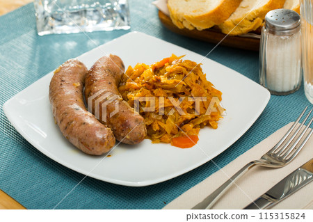 Sausages from meat served with braised cabbage, no people 115315824