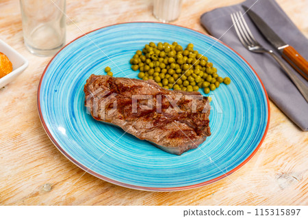 Grilled beef steak with pickled green peas on plate Grilled beef steak with pickled green peas on plate 115315897