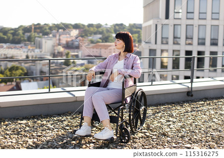 Young woman in wheelchair enjoying outdoor rooftop view Young woman in wheelchair enjoying outdoor rooftop view 115316275