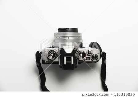 modern camera in retro style with a strap close-up, top view 115316830