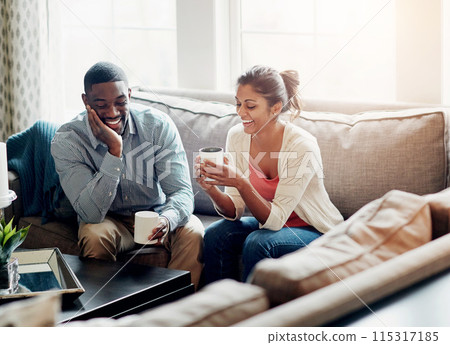 Couple, relax and coffee on sofa in morning for conversation or talking in living room. Man, woman and discussion at home chat, happy and married with tea for day plan or romantic date in summer Couple, relax and coffee on sofa in morning for conversation or talking in living room. Man, woman and discussion at home chat, happy and married with tea for day plan or romantic date in summer 115317185