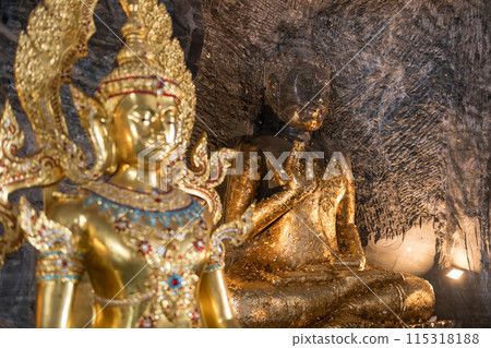 Ancient stone Buddha statue and gold god inside Suphan buri cave 115318188