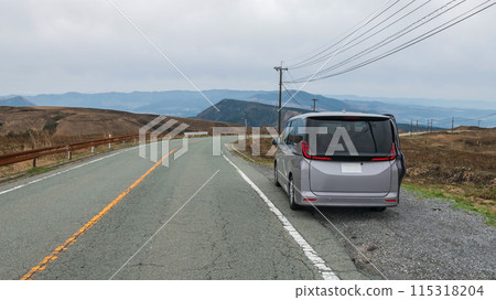 Van car on Aso Milk Road curve downhill road, Kumamoto 115318204
