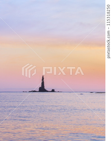 Winter in Hokkaido's Shakotan Peninsula: Candle Rock at sunrise viewed from the fishing port of Toyohama Town 115318250