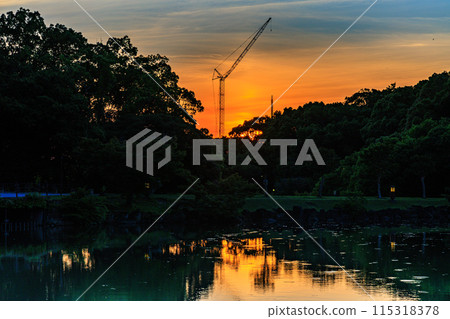 Evening view of Ukimido Hall at Sagiike Pond in Nara Park: The sun setting over Kofukuji Temple while painting the western sky golden② 115318378