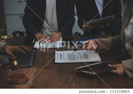 Judge gavel with Justice lawyers having team meeting at law firm background. Concepts of Law and Legal services. 115319665