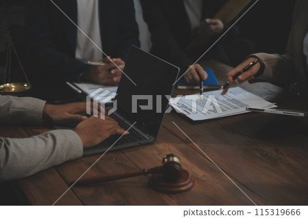 Judge gavel with Justice lawyers having team meeting at law firm background. Concepts of Law and Legal services. 115319666