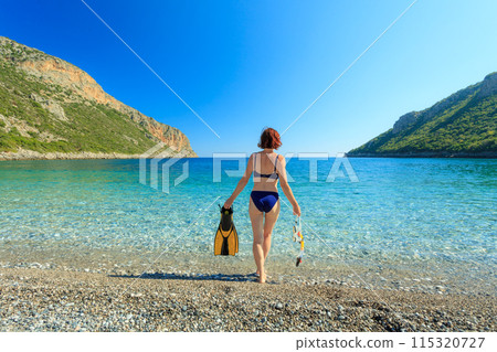 Woman with flippers snorkeling tube on beach Woman with flippers snorkeling tube on beach 115320727