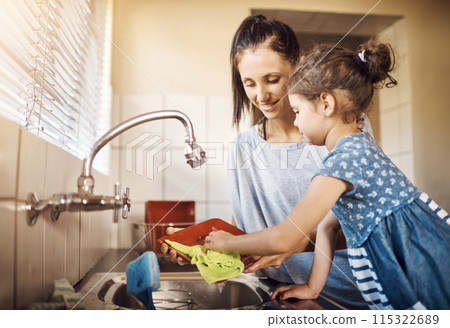 Mom, child and washing dishes in kitchen with cleaning, teaching and help in a family home. Learning, happy and love of parent and young girl together with bonding, support and sink with care 115322689