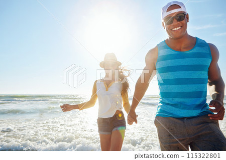 Couple, walking and holding hands in sea for outdoor romance, holiday and vacation in summer. Excited people in water splash with love, fun or energy for travel, health and wellness in beach portrait 115322801