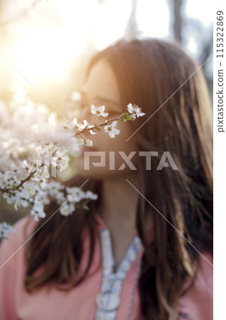 warm portrait of a sweet girl in the garden warm portrait of a sweet girl in the garden 115322869