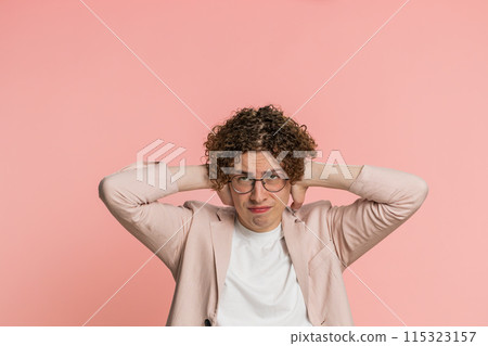 Annoyed irritated man covering ears gesturing no avoiding advice ignoring noise loud voices 115323157