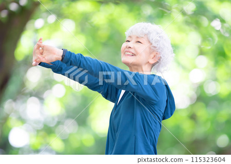 Woman in sportswear stretching Woman in sportswear stretching 115323604