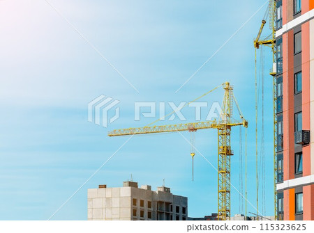 Construction site with cranes and building development. Urban engineering and industrial equipment 115323625