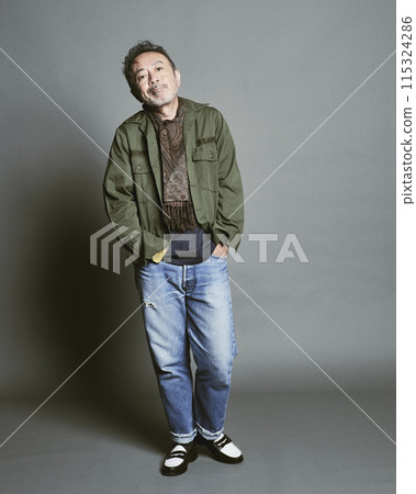 Portrait of a middle-aged man in casual clothes against a gray background Portrait of a middle-aged man in casual clothes against a gray background 115324286