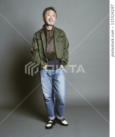 Portrait of a middle-aged man in casual clothes against a gray background Portrait of a middle-aged man in casual clothes against a gray background 115324287