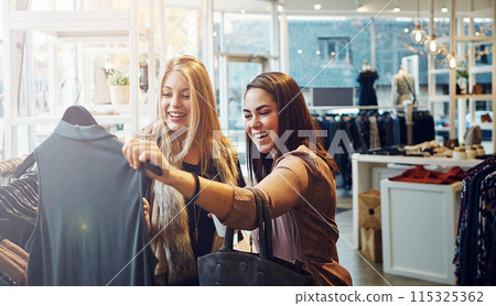 Fashion, shopping and friends with decision for clothes, sales and discount promotion at mall. Smile, retail shop and customer with fabric at boutique for purchase choice with women or girls laughing Fashion, shopping and friends with decision for clothes, sales and discount promotion at mall. Smile, retail shop and customer with fabric at boutique for purchase choice with women or girls laughing 115325362
