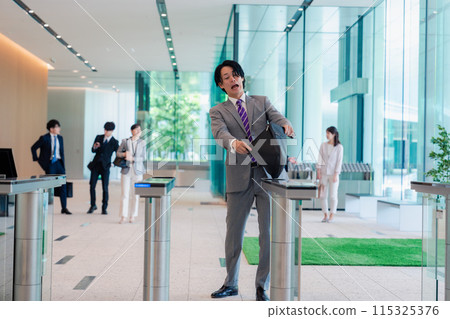 A businessman who is in a hurry because he forgot his employee ID card 115325376