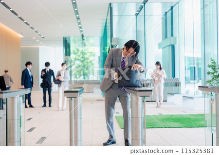A businessman who is in a hurry because he forgot his employee ID card 115325381