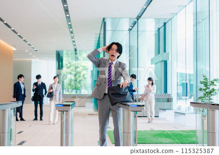 A businessman who is in a hurry because he forgot his employee ID card A businessman who is in a hurry because he forgot his employee ID card 115325387
