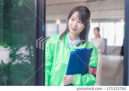 Event staff providing guidance with a smile 115325768