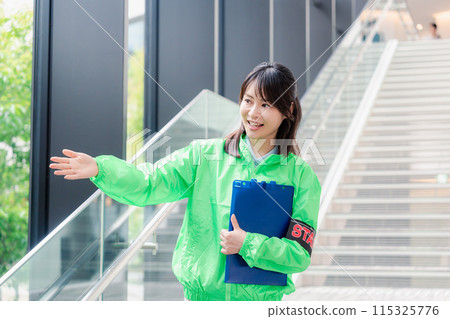 Event staff providing guidance with a smile 115325776