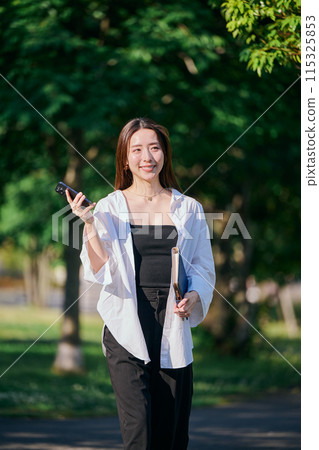 A young woman operating a smartphone A young woman operating a smartphone 115325853