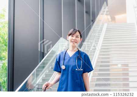 A doctor walking through a clean hospital 115326232