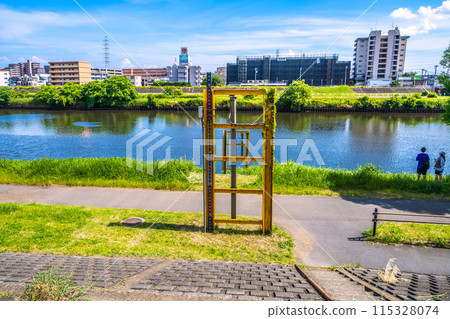 Yokohama cityscape in Japan in June. View of the Tsurumi River in front of the south exit of Shin-Tsunashima Station on the Tokyu Shin-Yokohama Line (June 8th) Yokohama cityscape in Japan in June. View of the Tsurumi River in front of the south exit of Shin-Tsunashima Station on the Tokyu Shin-Yokohama Line (June 8th) 115328074