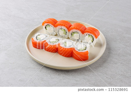 Sushi roll (Philadelphia) with salmon, cream cheese, Sushi menu. Japanese food. Sushi roll (Philadelphia) with salmon, cream cheese, Sushi menu. Japanese food. 115328691