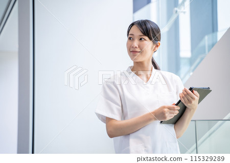 A nurse entering electronic medical records at a hospital 115329289