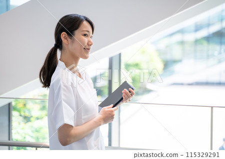 A nurse entering electronic medical records at a hospital A nurse entering electronic medical records at a hospital 115329291