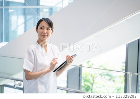 A nurse entering electronic medical records at a hospital A nurse entering electronic medical records at a hospital 115329292