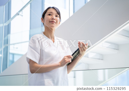 A nurse entering electronic medical records at a hospital 115329295
