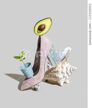 A surreal piece of art featuring a high heel shoe adorned with an avocado, seashell, and small plant A surreal piece of art featuring a high heel shoe adorned with an avocado, seashell, and small plant 115329352