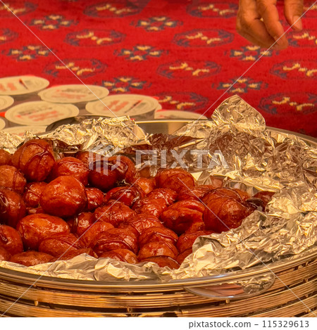 Lokma piled high a popular middle eastern dessert. Sweet donuts in syrup. 115329613