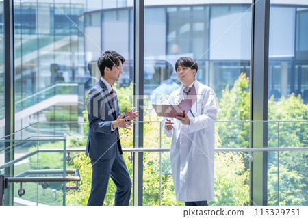 Doctor and businessman having a meeting at the hospital 115329751