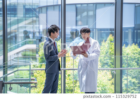 Doctor and businessman having a meeting at the hospital Doctor and businessman having a meeting at the hospital 115329752