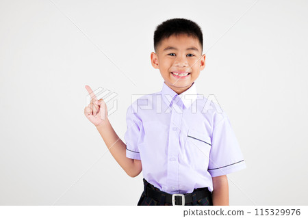 Portrait smile Asian little boy primary posing point finger to side away studio isolated white background, happy cute man kid wear school uniform plaid innocence and curiosity, back to school concept Portrait smile Asian little boy primary posing point finger to side away studio isolated white background, happy cute man kid wear school uniform plaid innocence and curiosity, back to school concept 115329976