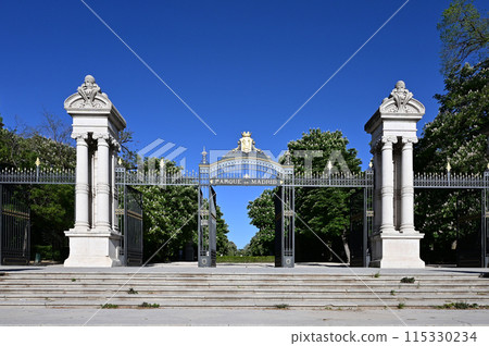 Spain Gate in El Retiro Park in Madrid, Spain on clear sunny April morning. 115330234